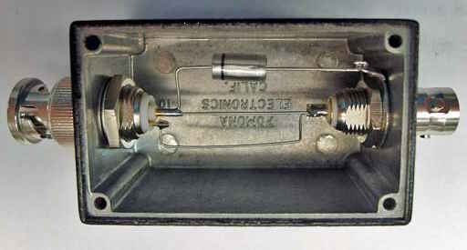 An image of the interior of a 2450-CAL-KIT showing the 1nF capacitor and wire connectors between triax lugs.