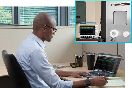 Engineer at his bench working space using remote software to control an oscilloscope and performaning measurements and analysis remotely