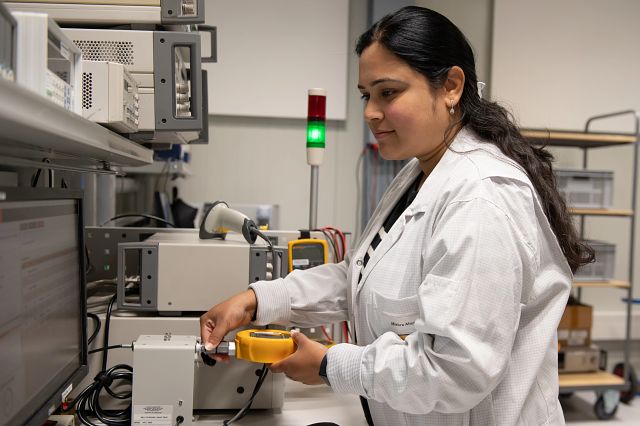 Lab technician at bench testing an instrument.